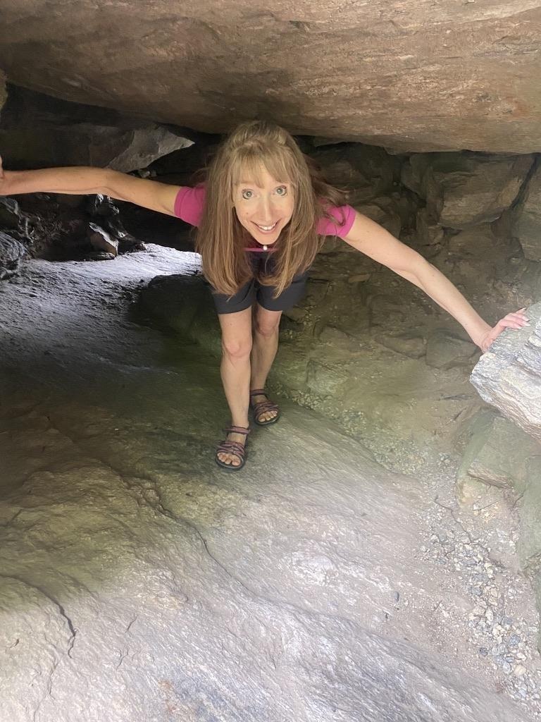 Kris Freeman looking out through a cave opening